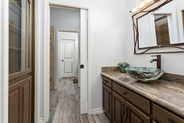 a view of bathroom with a sink and mirror