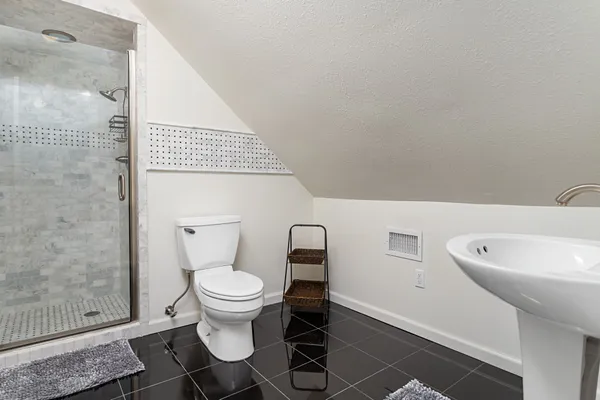 a white toilet sitting next to a bathroom sink