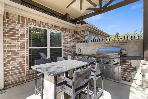 a roof deck with a dining table and chairs with wooden floor