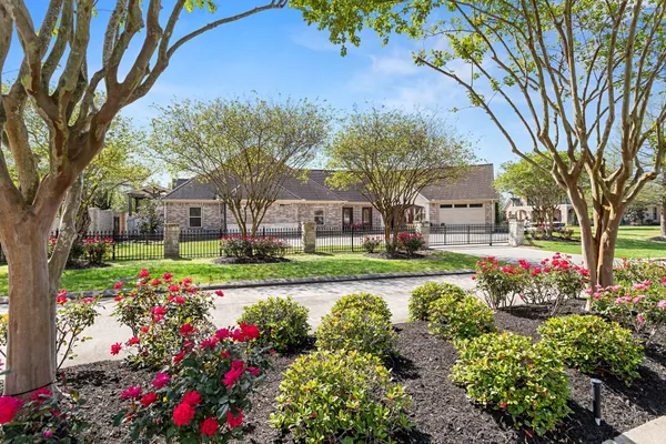 a view of a house with a big yard and large trees