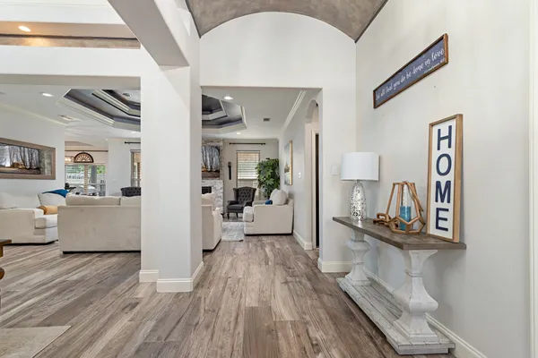 a living room with furniture and wooden floor