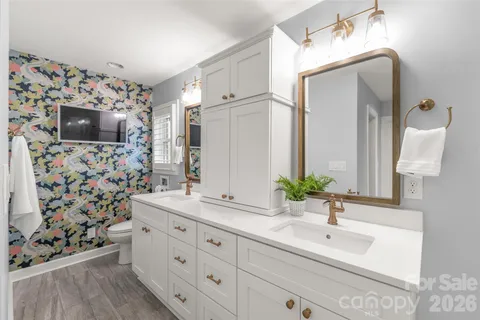 a bathroom with a sink double vanity and mirror