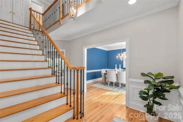 a view of entryway and hall with wooden floor