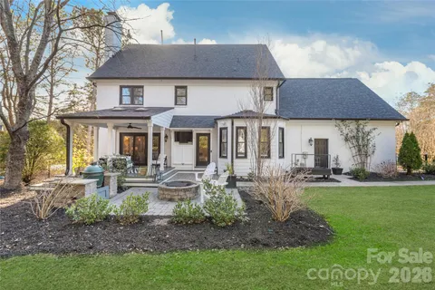 a front view of a house with garden and patio