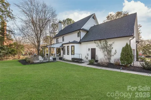a backyard of a house with table and chairs