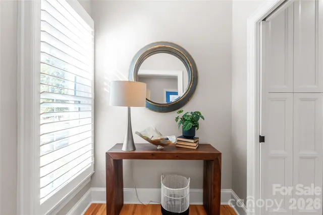 a living room with a table and windows