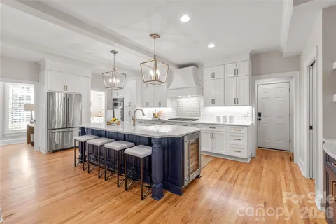 a large kitchen with lots of counter space a sink appliances and cabinets