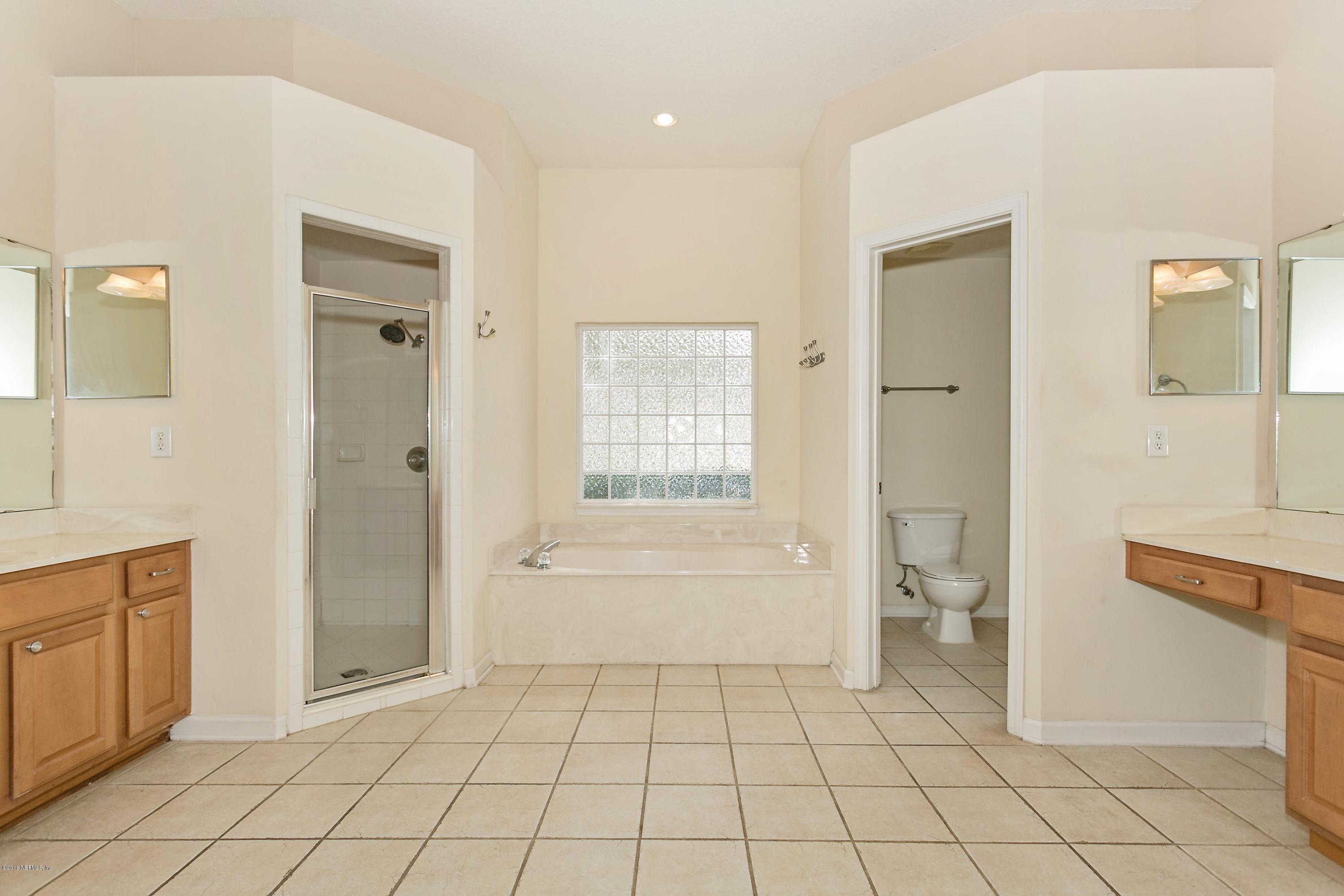 2809 Hidden Stagecoach Road Jacksonville, FL 32223 - Photo 12 of 25 a bathroom with a sink a toilet and shower