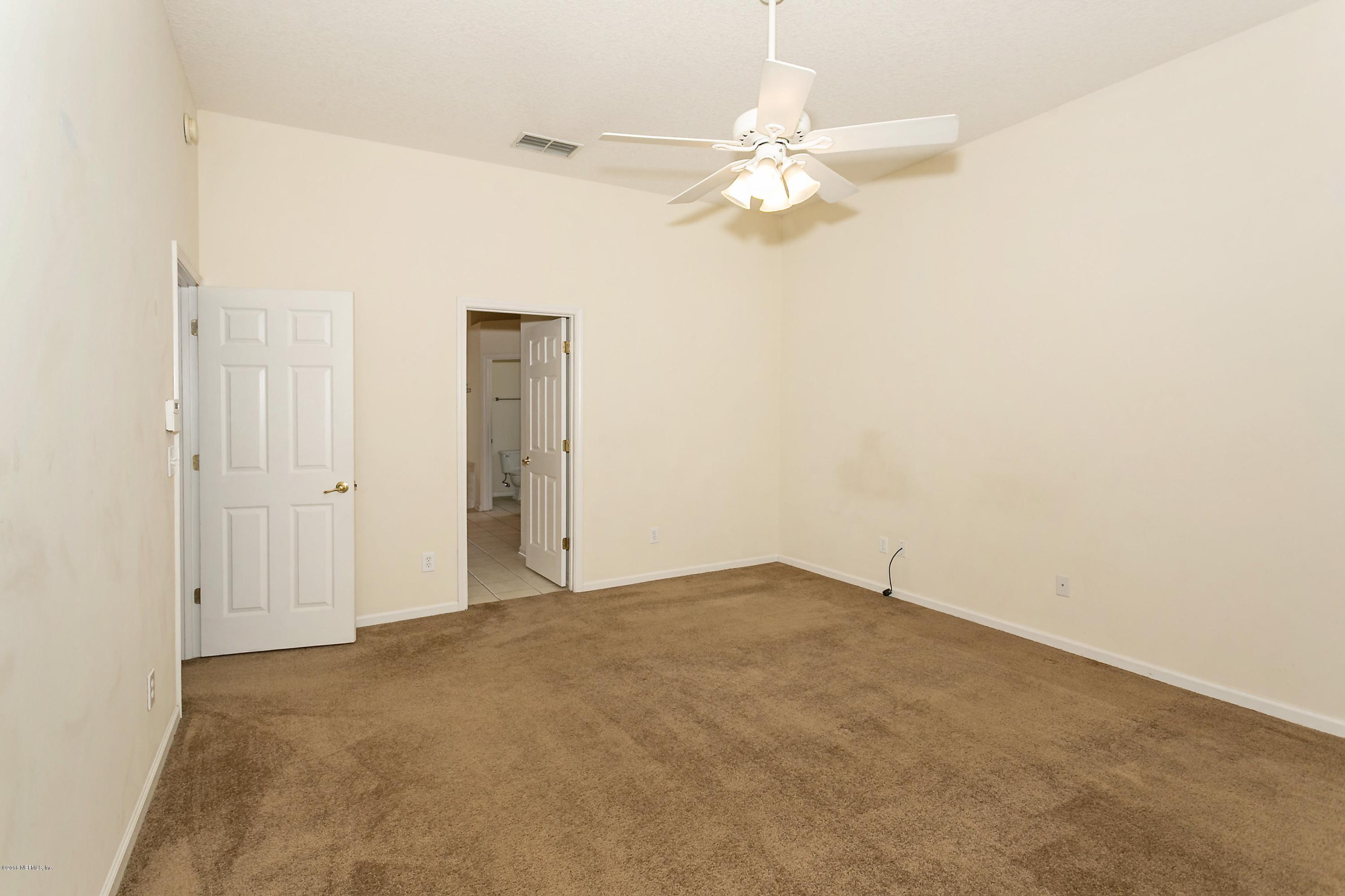 2809 Hidden Stagecoach Road Jacksonville, FL 32223 - Photo 13 of 25 an empty room with a chandelier fan and closet