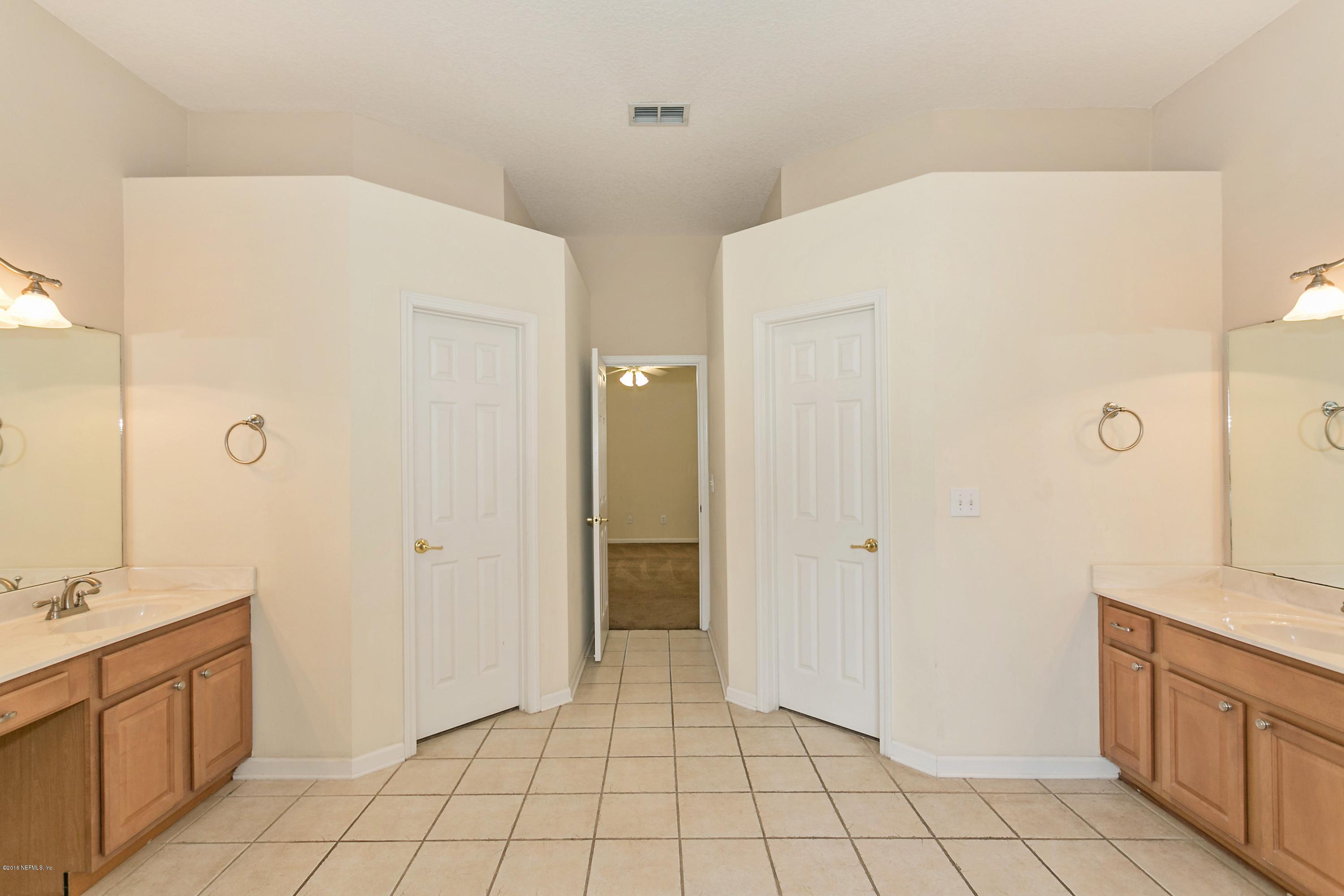2809 Hidden Stagecoach Road Jacksonville, FL 32223 - Photo 15 of 25 a spacious bathroom with a granite countertop sink a mirror and a shower