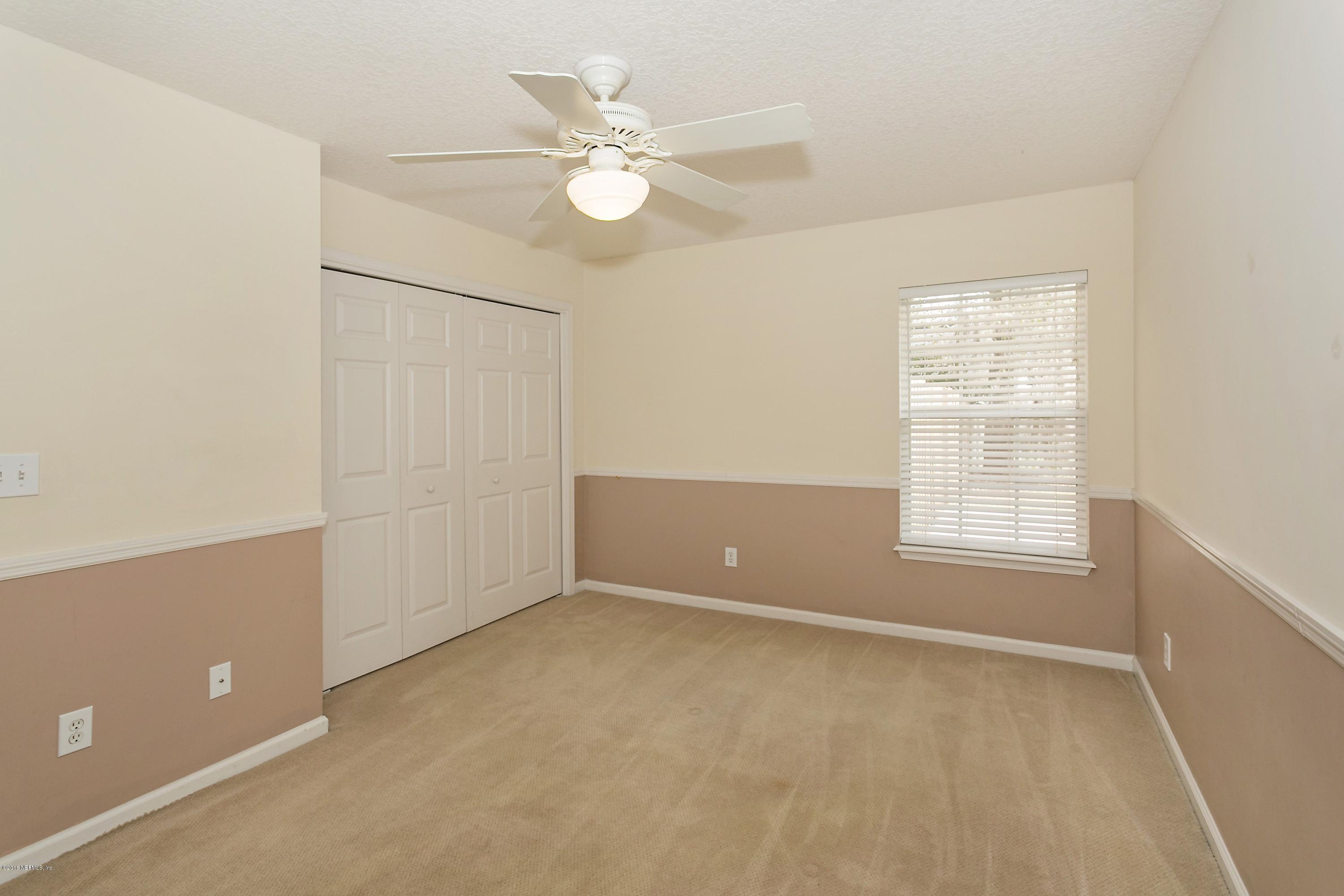 2809 Hidden Stagecoach Road Jacksonville, FL 32223 - Photo 16 of 25 an empty room with a window and a fan