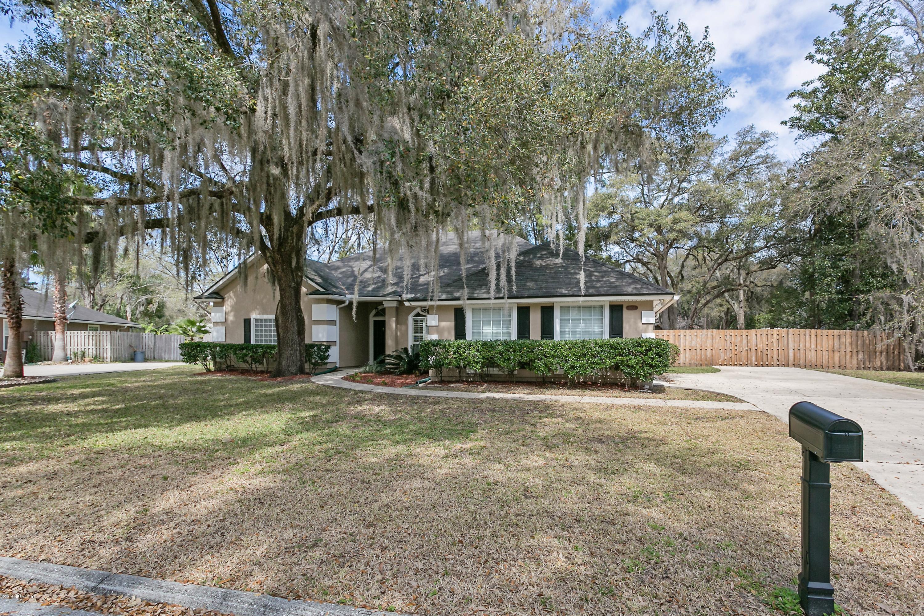 2809 Hidden Stagecoach Road Jacksonville, FL 32223 - Photo 25 of 25 a front view of a house with a yard and trees