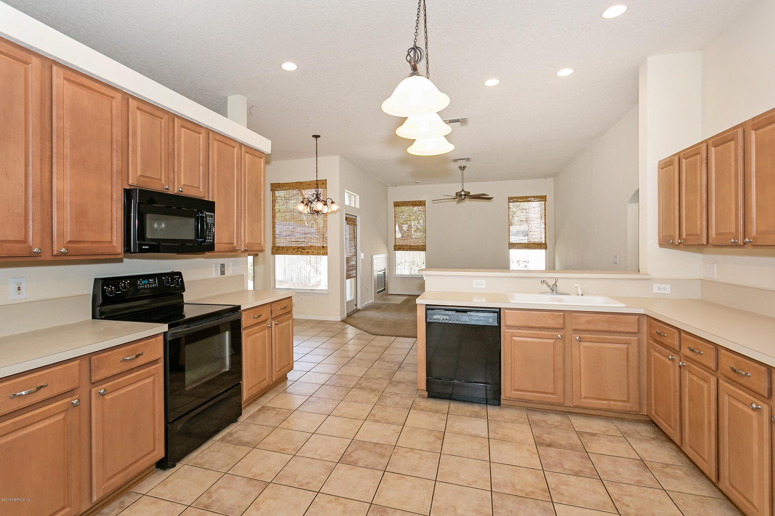 2809 Hidden Stagecoach Road Jacksonville, FL 32223 - Photo 6 of 25 a large kitchen with cabinets stainless steel appliances a sink and a counter top space