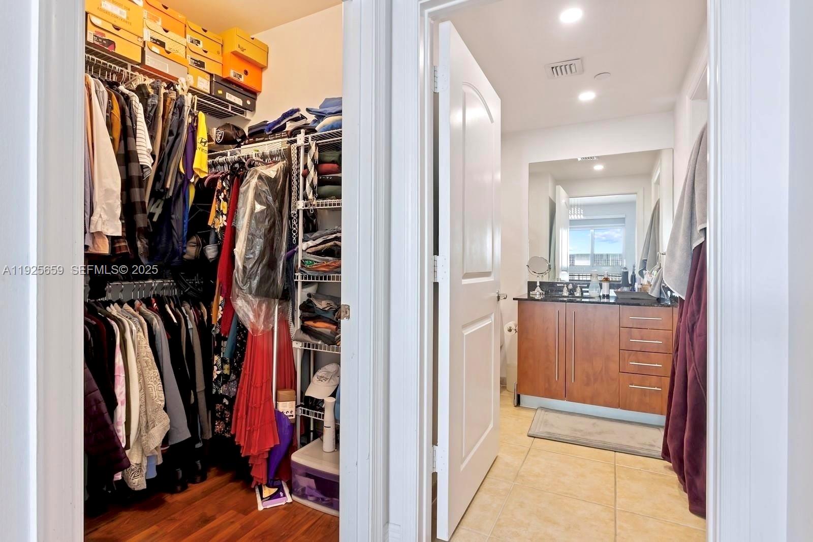 7350 Southwest 89th Street, Unit 607S Miami, FL 33156 - Photo 11 of 19 a view of walk in closet with clothes