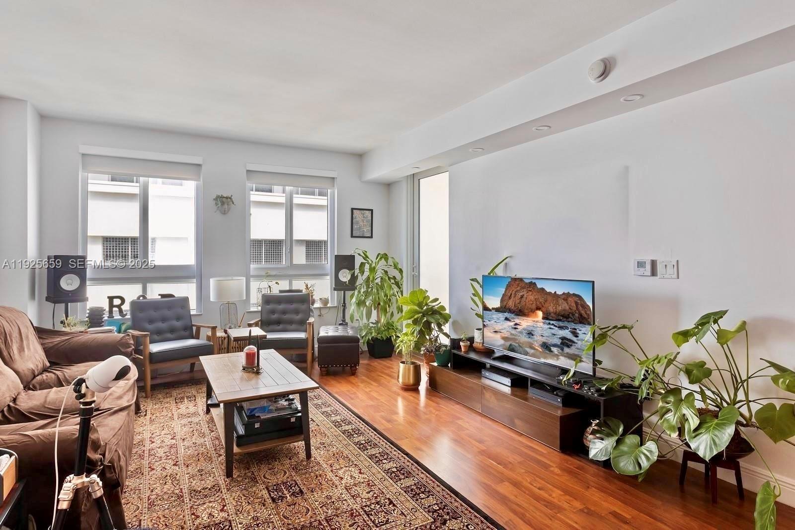 7350 Southwest 89th Street, Unit 607S Miami, FL 33156 - Photo 2 of 19 a living room with furniture fireplace and a large window