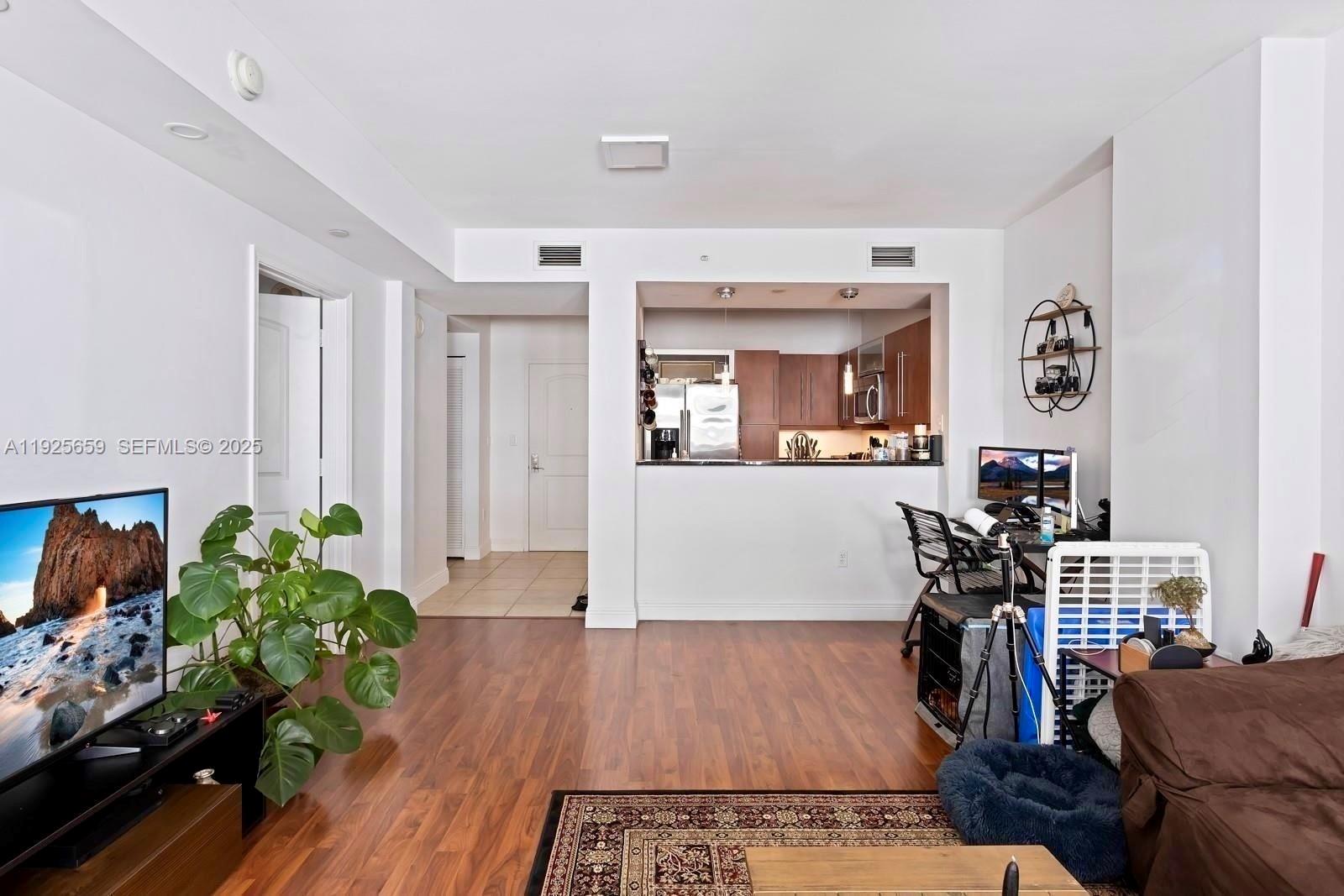 7350 Southwest 89th Street, Unit 607S Miami, FL 33156 - Photo 4 of 19 a living room with furniture and wooden floor