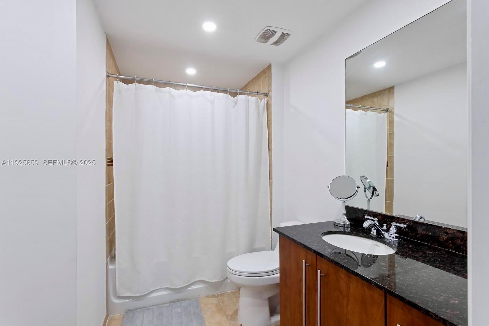 7350 Southwest 89th Street, Unit 607S Miami, FL 33156 - Photo 10 of 19 a bathroom with a granite countertop sink toilet and shower
