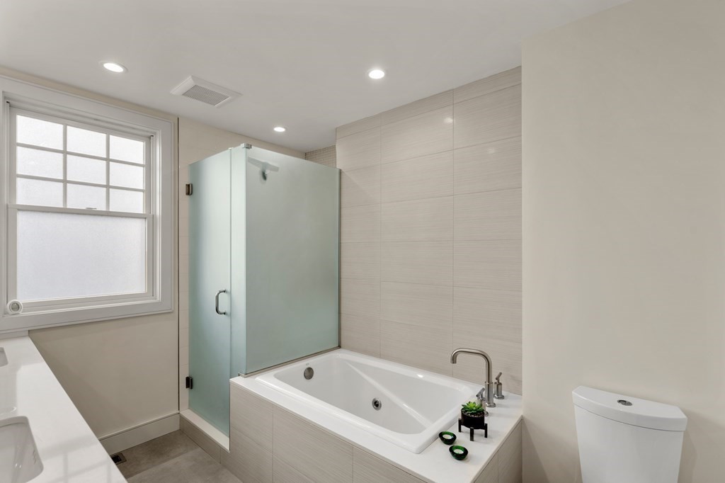 106 Westbourne Terrace, Unit 1 Brookline, MA 02446 - Photo 14 of 22 a bathroom with a bathtub a sink a toilet and a shower