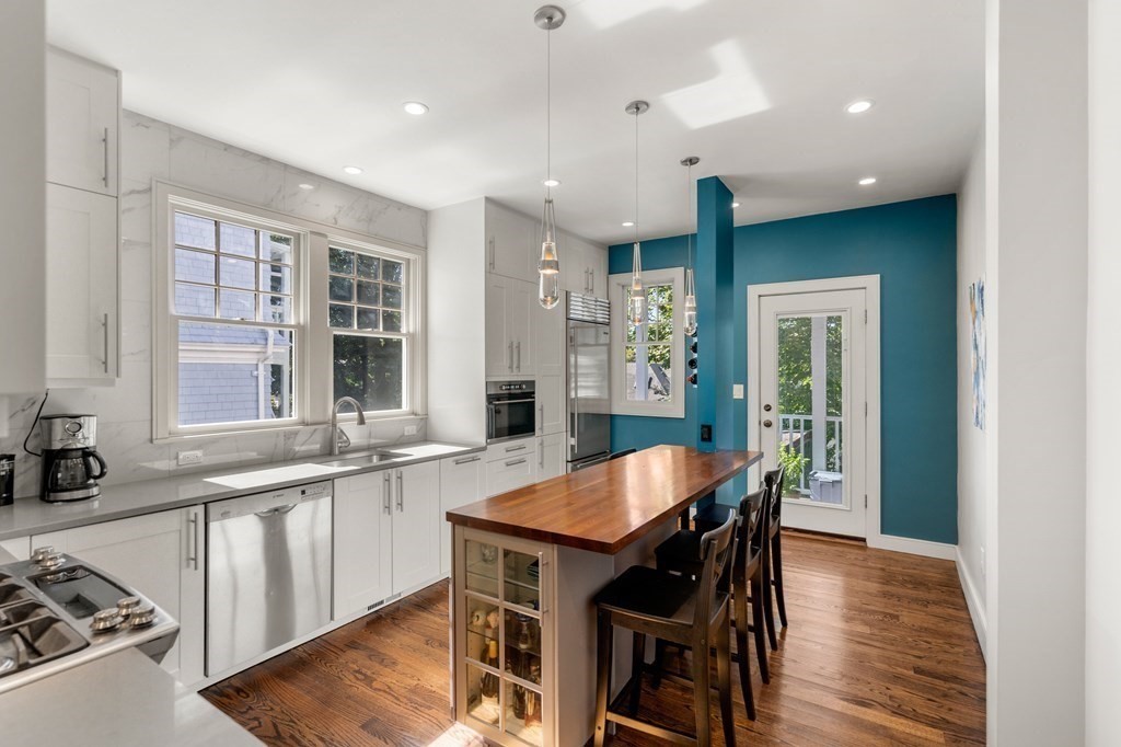 106 Westbourne Terrace, Unit 1 Brookline, MA 02446 - Photo 4 of 22 a large kitchen with a table and chairs in it