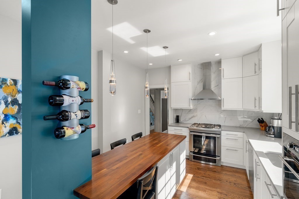 106 Westbourne Terrace, Unit 1 Brookline, MA 02446 - Photo 5 of 22 a kitchen with stainless steel appliances granite countertop a stove refrigerator sink and cabinets