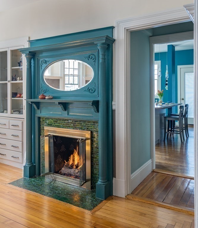 106 Westbourne Terrace, Unit 1 Brookline, MA 02446 - Photo 9 of 22 a view of a livingroom with a fireplace wooden floor and a fire place