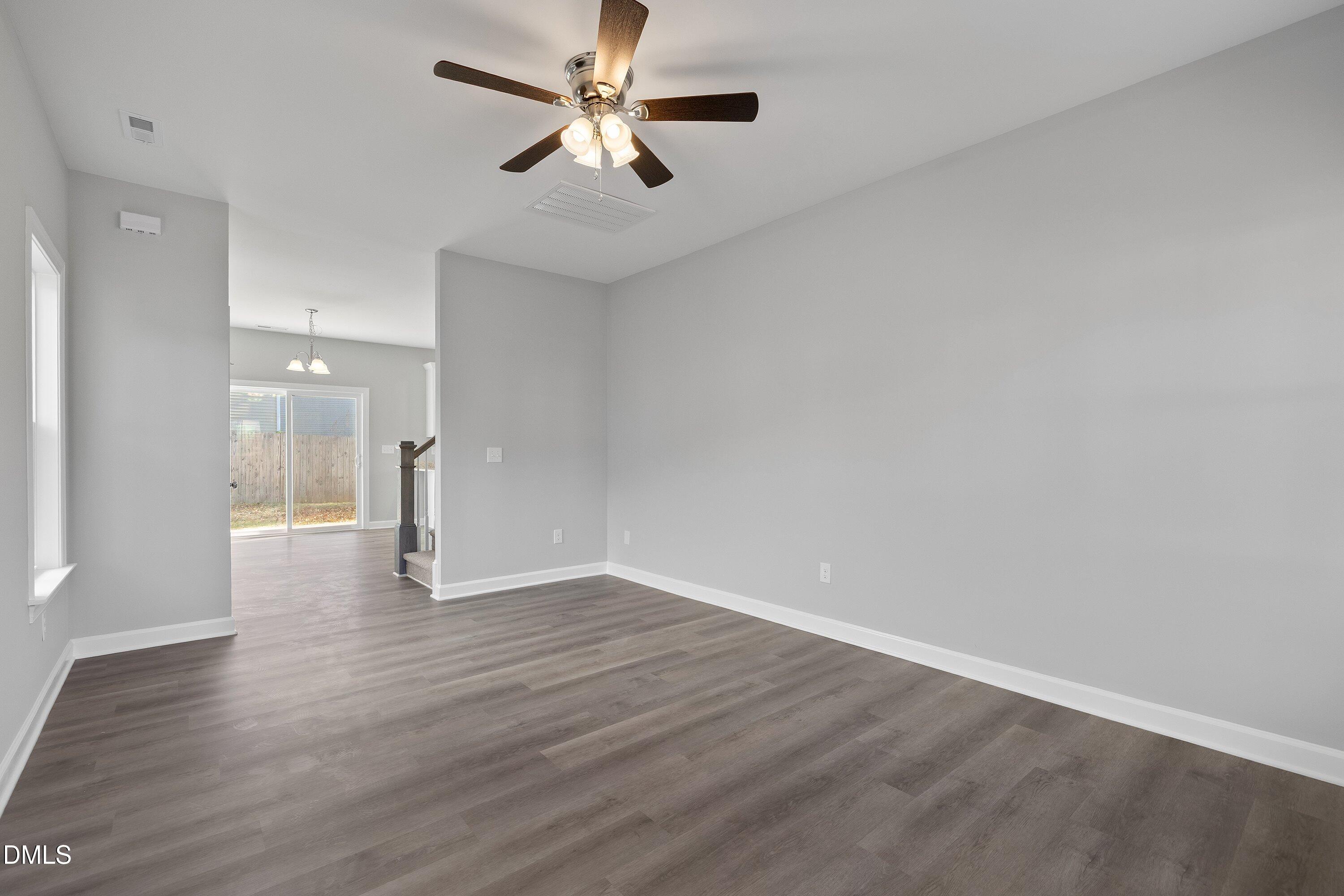 1808 Falls Landing Drive Raleigh, NC 27614 - Photo 6 of 23 an empty room with wooden floor and windows