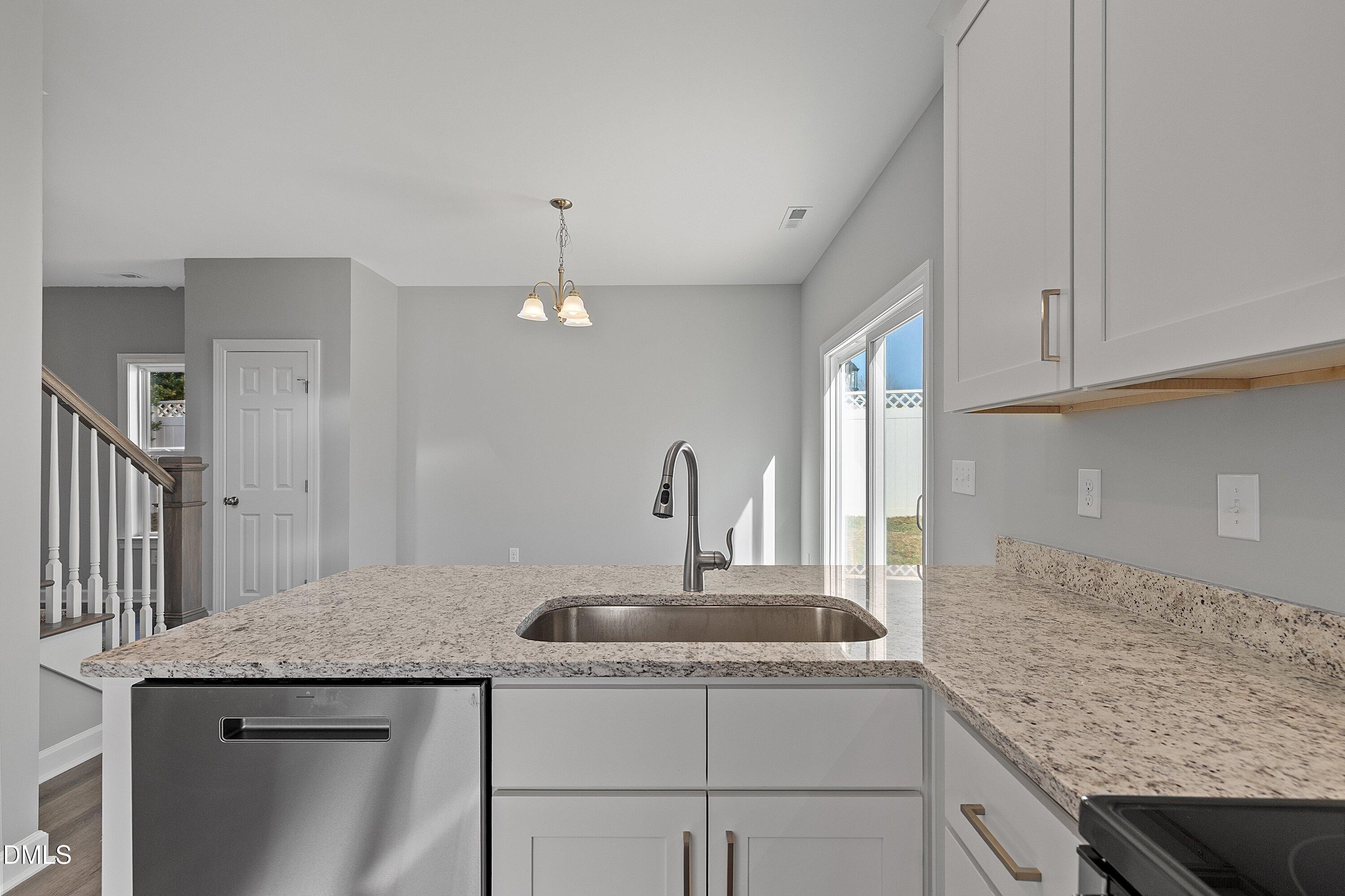 1808 Falls Landing Drive Raleigh, NC 27614 - Photo 10 of 23 a kitchen with granite countertop kitchen island stainless steel appliances a sink stove and cabinets
