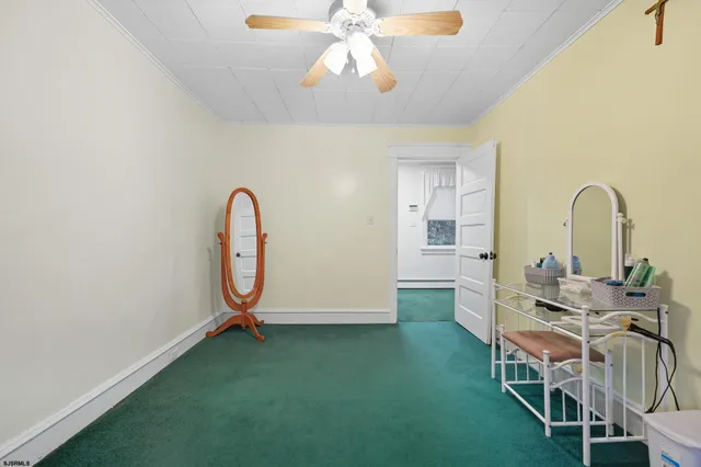 a living room with dining room and chandelier