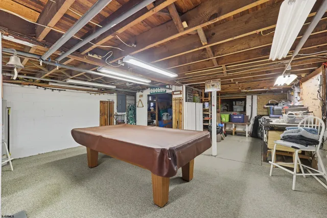 a room with pool table and chairs