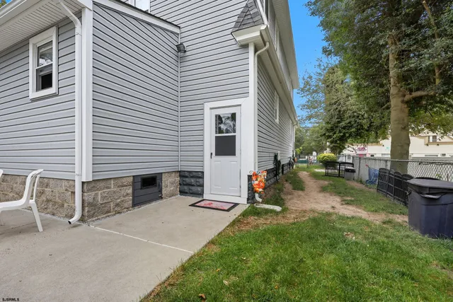 a view of a backyard with sitting area