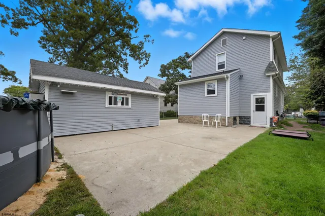a backyard of a house with table and chairs