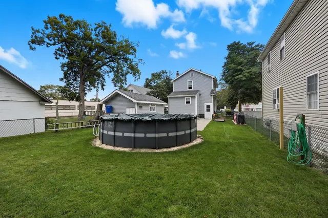 a view of a house with a backyard porch and sitting area