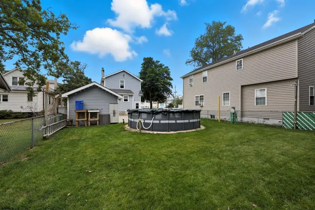 a view of house with backyard