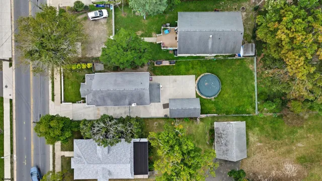 an aerial view of a house with outdoor space and street view
