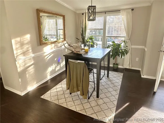 a kitchen with stainless steel appliances granite countertop a sink a stove a refrigerator cabinets and a window