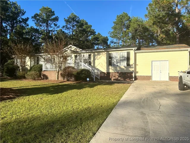 a view of a house with a yard
