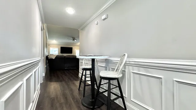 a view of a hallway with wooden floor and a window