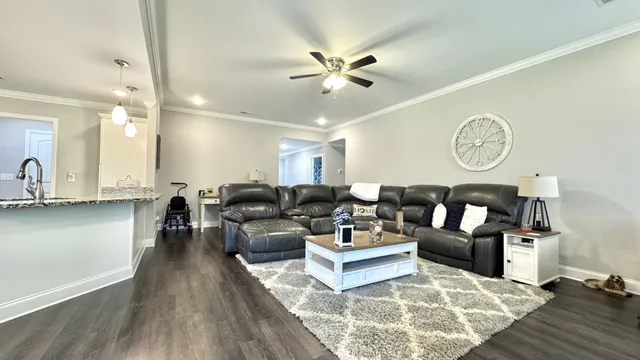 a living room with furniture and flat screen tv