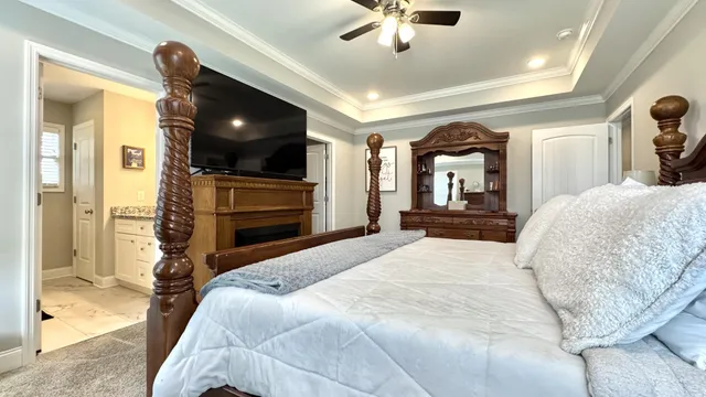 a bedroom with a bed and a chandelier