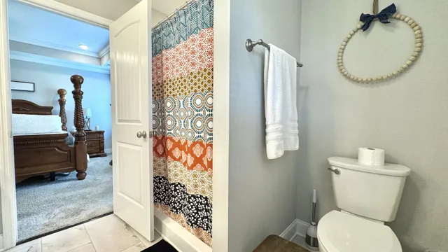 a view of a livingroom with furniture flat screen tv wooden floor and a ceiling fan