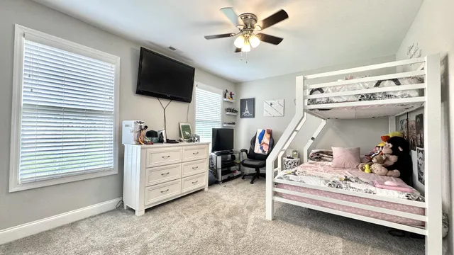 a bedroom that has a bed and a chair in it