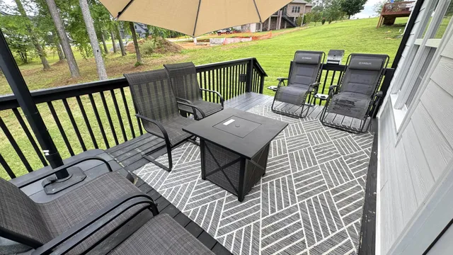 a view of a white house with a big yard and potted plants