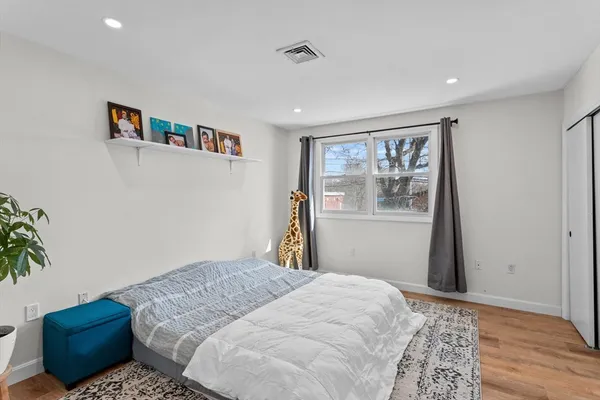 a bedroom with a large bed and a window