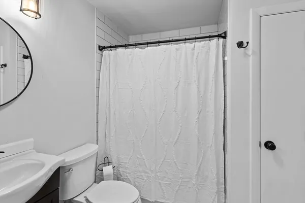 a white toilet sitting next to a bathroom sink