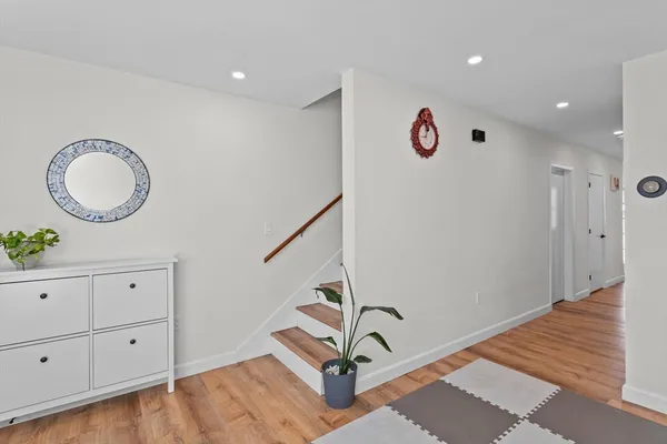 a view of a room with wooden floor