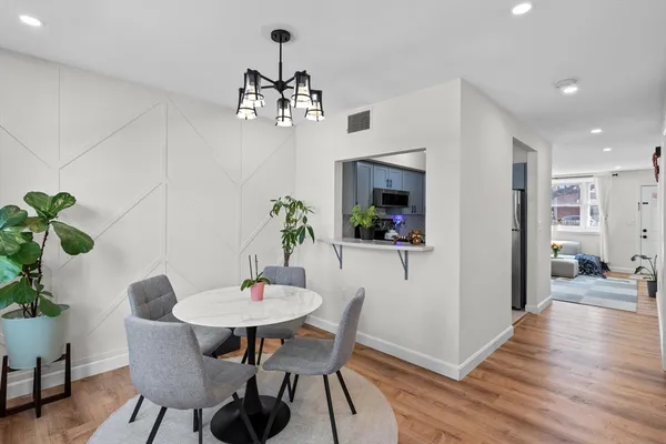 a view of a dining room with furniture wooden floor and a chandelier