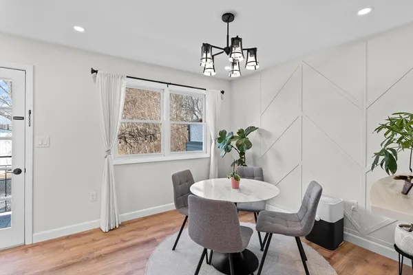 a view of a dining room with furniture window and wooden floor