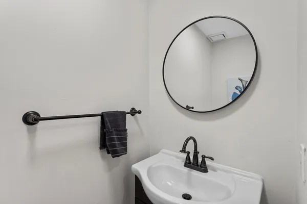 a bathroom with a sink and mirror