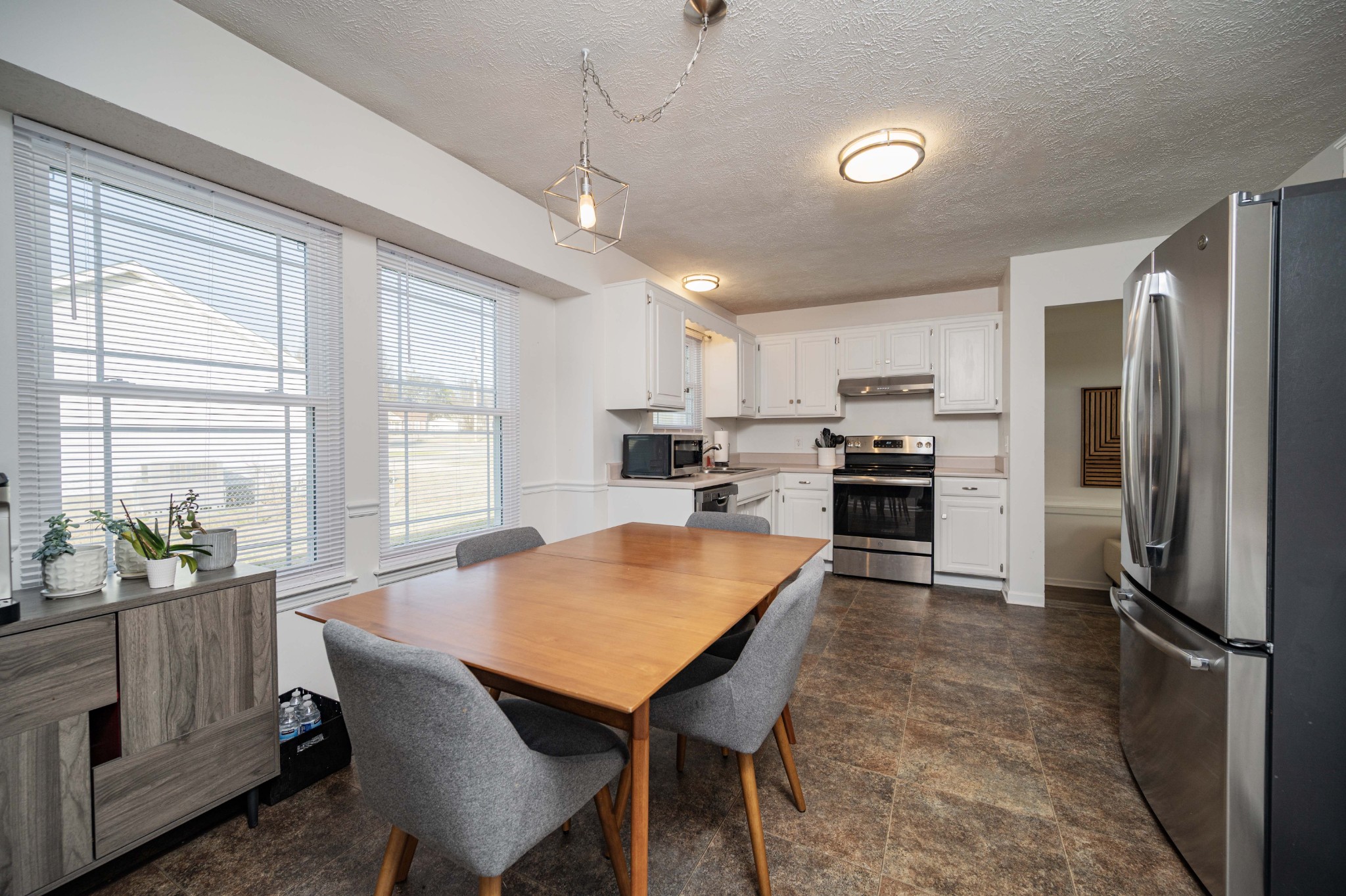 642 Rock Springs Road Smyrna, TN 37167 - Photo 13 of 49 a kitchen with refrigerator a sink and chairs