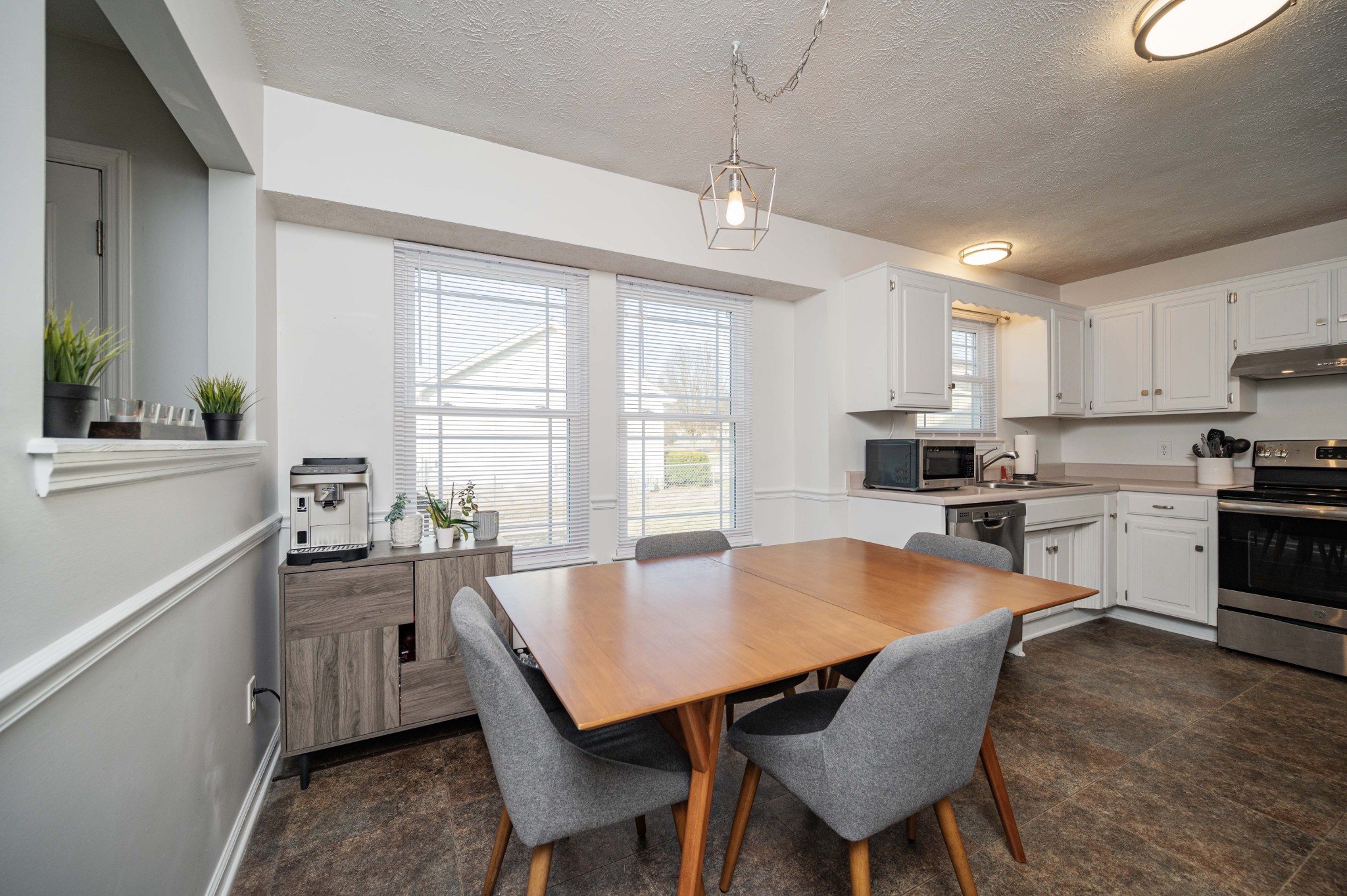 642 Rock Springs Road Smyrna, TN 37167 - Photo 14 of 49 a kitchen with a dining table chairs stainless steel appliances and windows